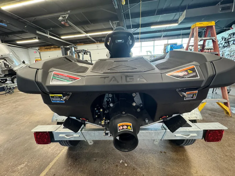 Slide: The Image of 2024 Taiga Orca watercraft in a garage, rear view showing design and features. - 14