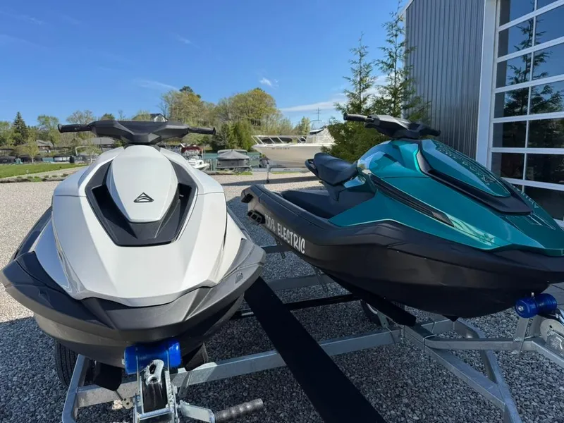 Slide: The Image of 2024 Taiga Orca electric jet skis on a trailer, parked outdoors. - 3