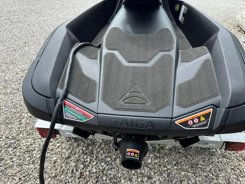 Slide: The Image of 2024 Taiga Orca electric jet ski in vibrant red, parked on grass. - 4