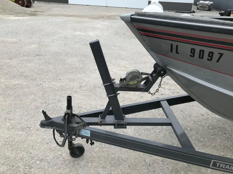 Slide: The Image of 1998 Lund 1775 Pro-V SE boat on trailer, showing front hitch and winch system. - 12