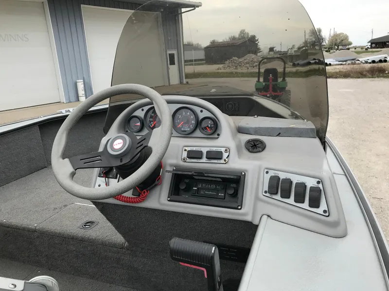 Slide: The Image of 1998 Lund 1775 Pro-V SE boat dashboard with steering wheel and instrument panel. - 19
