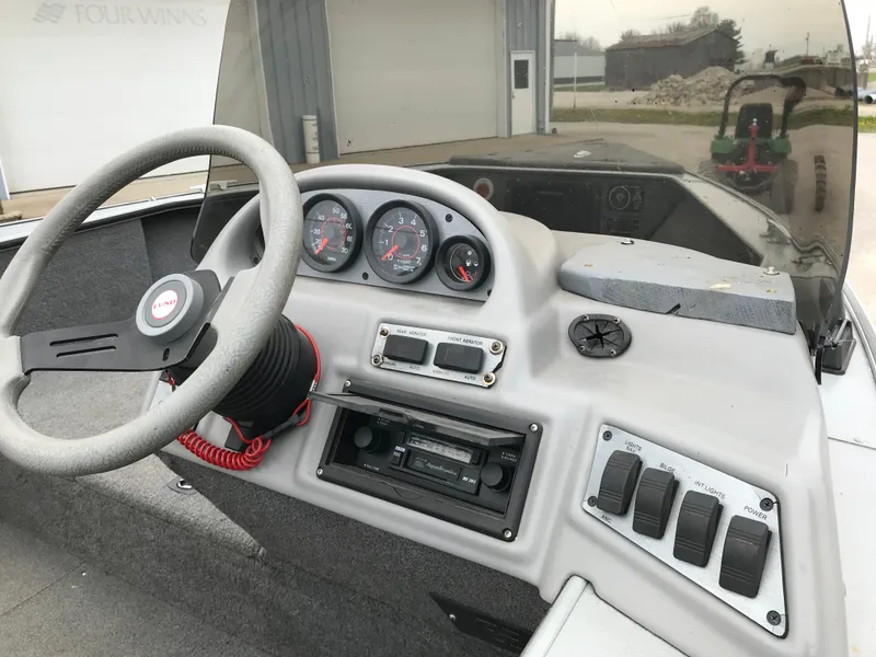 Slide: The Image of 1998 Lund 1775 Pro-V SE boat dashboard with steering wheel and instrument panel. - 23