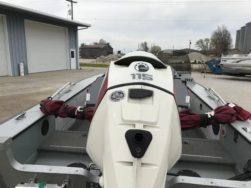 Slide: The Image of 1998 Lund 1775 Pro-V SE boat with 115 HP outboard motor, parked outdoors. - 5