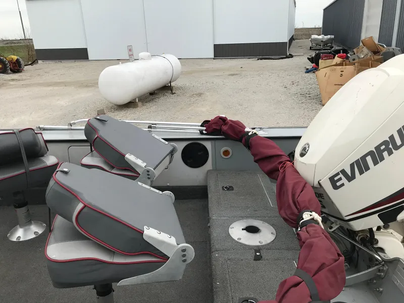 Slide: The Image of 1998 Lund 1775 Pro-V SE boat interior with Evinrude motor and gray seating. - 6