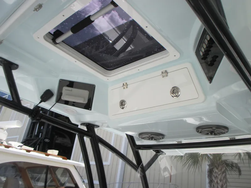 Slide: The Image of 2023 Sea Fox 328 Commander boat interior with hatch, speakers, and storage compartment. - 17