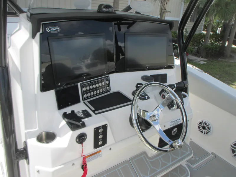 Slide: The Image of 2023 Sea Fox 328 Commander boat dashboard with dual screens and steering wheel. - 21