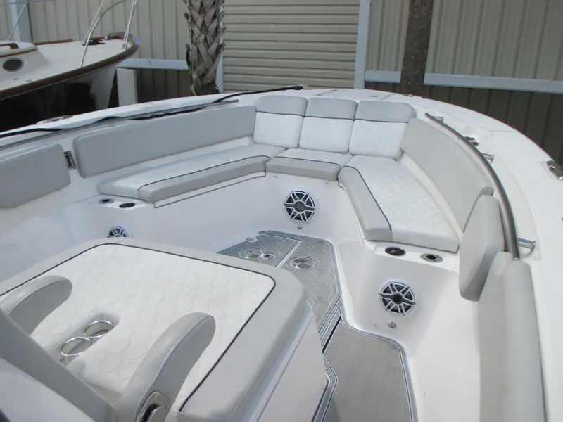 Slide: The Image of 2023 Sea Fox 328 Commander boat interior with cushioned seating and cup holders. - 24