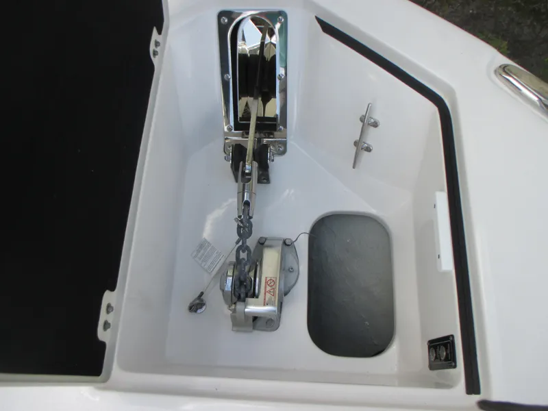 Slide: The Image of Anchor compartment of 2023 Sea Fox 328 Commander boat, featuring a winch and chain. - 27
