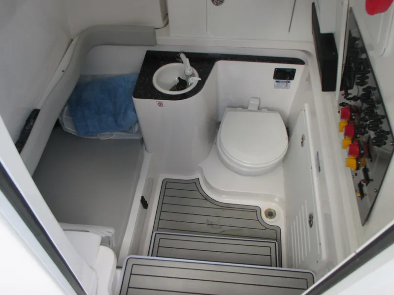 Slide: The Image of 2023 Sea Fox 328 Commander boat bathroom with toilet, sink, and control panel. - 29
