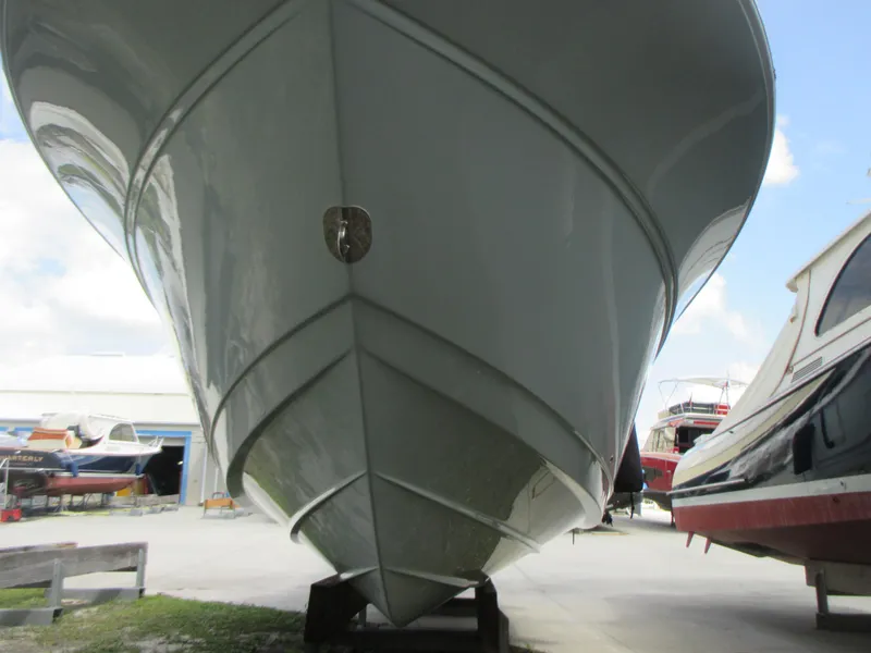 Slide: The Image of 2023 Sea Fox 328 Commander boat hull in storage, viewed from the front. - 3