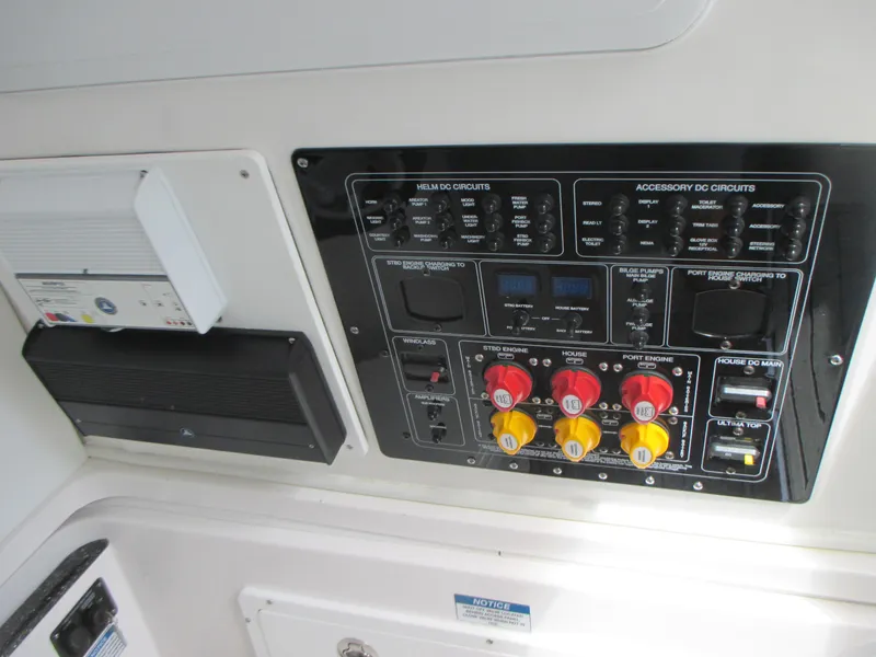 Slide: The Image of Control panel of 2023 Sea Fox 328 Commander boat with various switches and circuit breakers. - 32