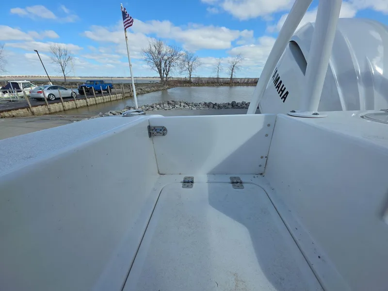 Slide: The Image of 2022 Sea Pro 239 Center Console boat with Yamaha engine, docked near a flagpole and parked cars. - 17