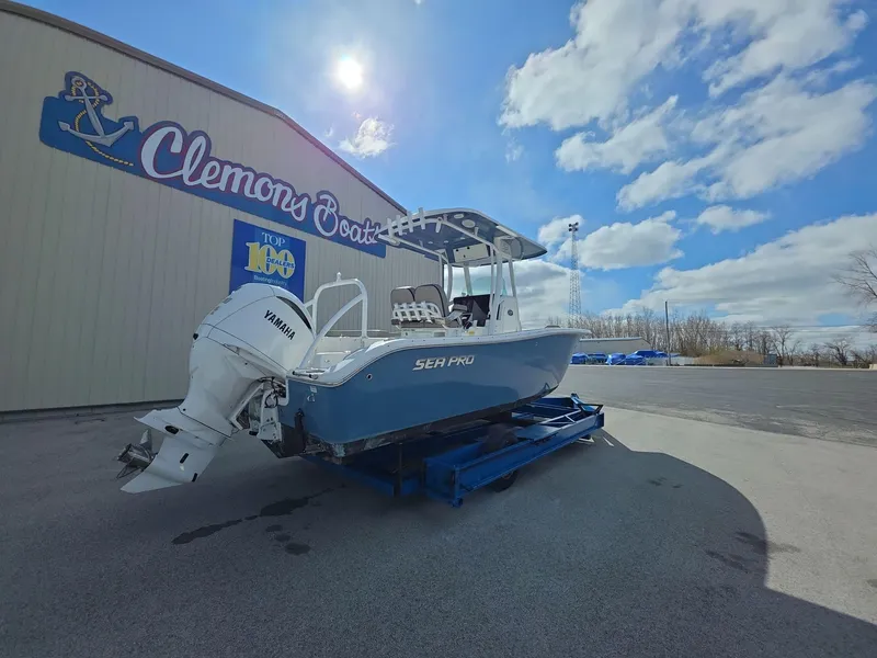 Slide: The Image of 2022 Sea Pro 239 Center Console boat outside Clemons Boats dealership under a blue sky. - 3