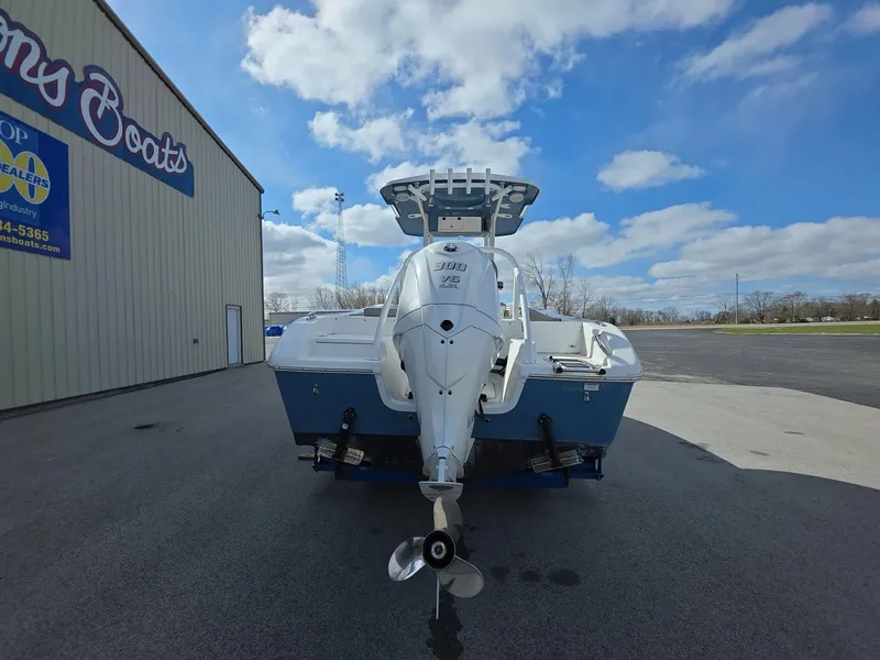 Slide: The Image of 2022 Sea Pro 239 Center Console boat parked outside dealership under blue sky. - 4