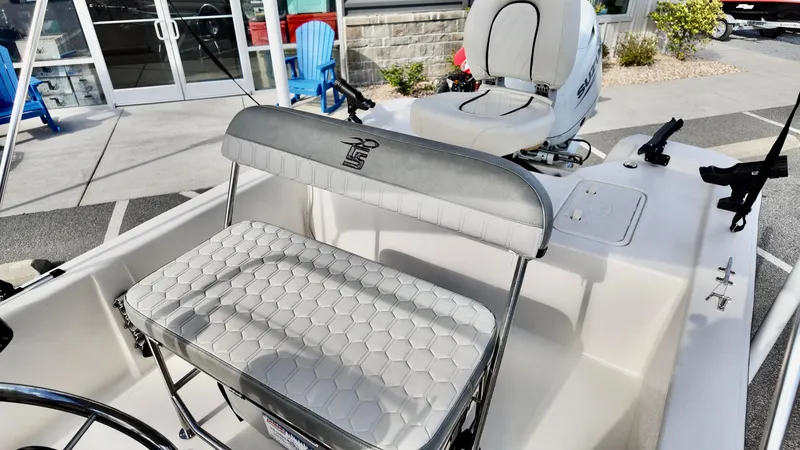 Slide: The Image of 2024 Carolina Skiff e18 JVX boat interior with seating and steering console. - 11