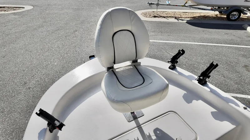 Slide: The Image of 2024 Carolina Skiff e18 JVX boat seat with rod holders in a parking lot. - 13