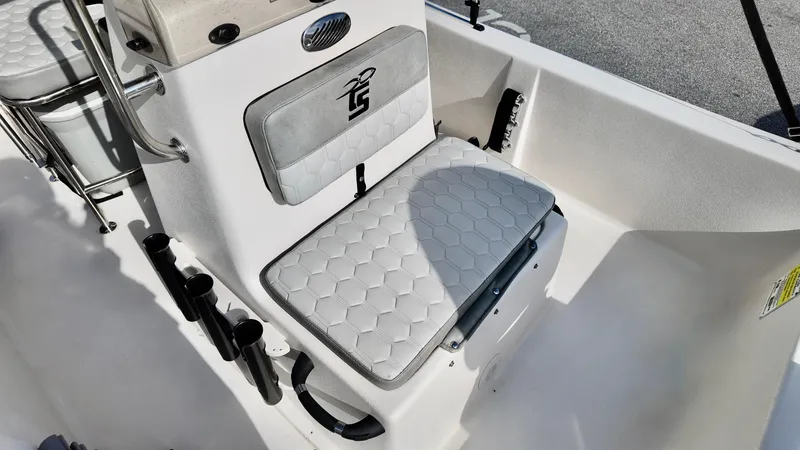 Slide: The Image of 2024 Carolina Skiff e18 JVX boat interior with cushioned seating and rod holders. - 14