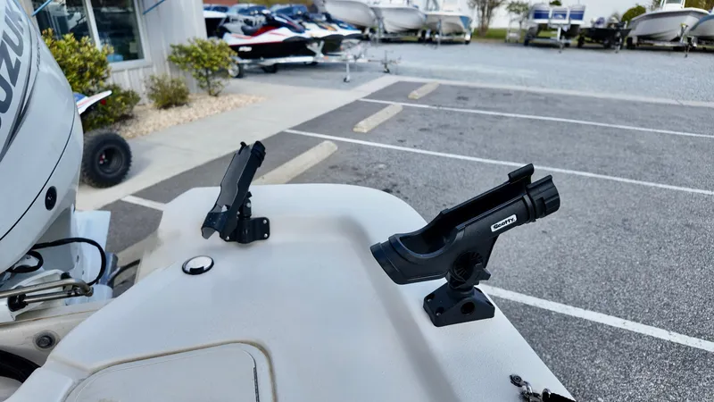 Slide: The Image of 2024 Carolina Skiff e18 JVX boat with rod holders in a parking lot. - 5