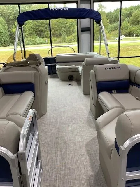 Slide: The Image of 2021 Trifecta 22 FR LE pontoon boat interior with beige seating and blue accents. - 3