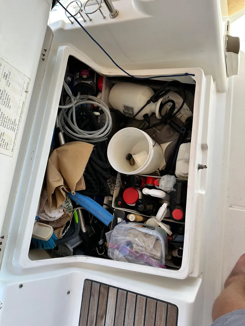 Slide: The Image of Storage compartment on a 2012 Beneteau Oceanis 41 sailboat, filled with various boating supplies. - 18