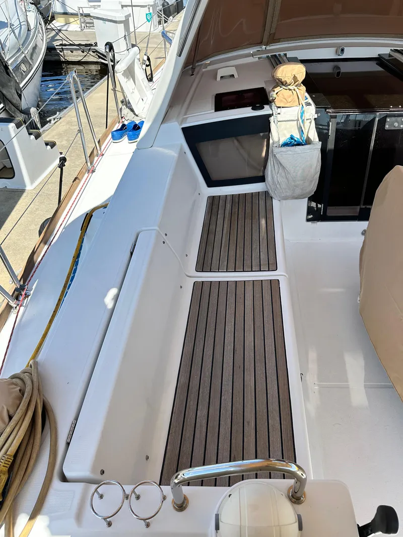 Slide: The Image of Beneteau Oceanis 41 sailboat deck, 2012 model, featuring teak flooring and docked at a marina. - 20