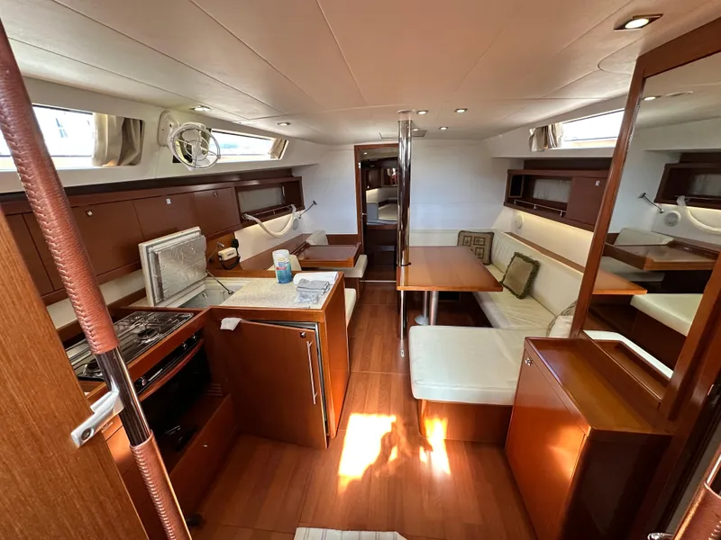 Slide: The Image of Interior of 2012 Beneteau Oceanis 41 yacht with kitchen and seating area. - 30