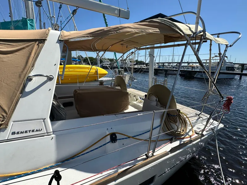 Slide: The Image of Beneteau Oceanis 41 sailboat, 2012 model, docked at marina with beige canopy. - 8