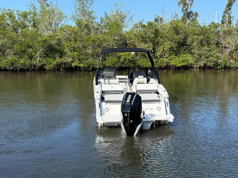 Slide: The Image of 2025 Cobalt R6 Outboard boat on calm water, surrounded by lush greenery. - 5