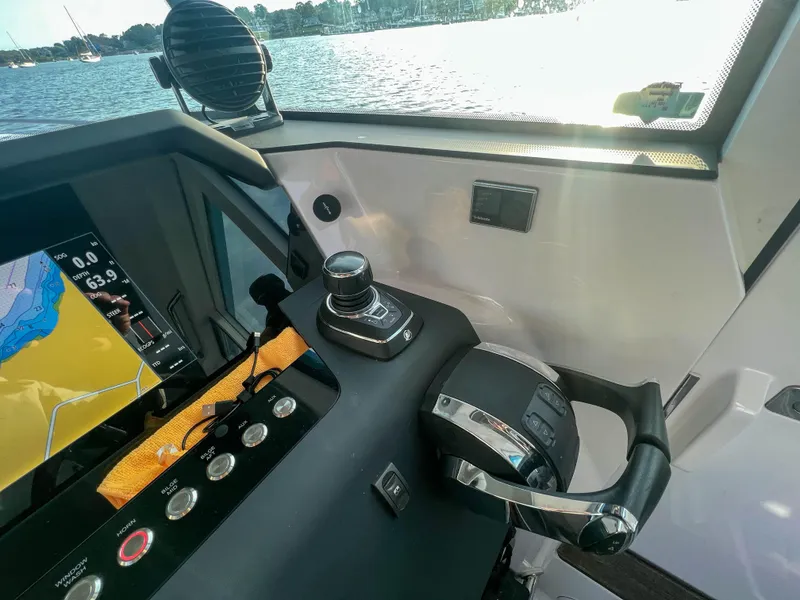 Slide: The Image of Control panel of 2020 Axopar 37 XC boat with navigation screen and throttle lever. - 12