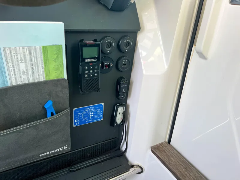 Slide: The Image of Control panel of 2020 Axopar 37 XC boat with Simrad radio and storage pocket. - 13