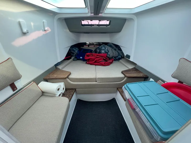 Slide: The Image of 2020 Axopar 37 XC cabin interior with seating, storage, and natural light. - 15