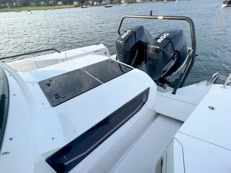 Slide: The Image of 2020 Axopar 37 XC boat with twin outboard engines on a calm water backdrop. - 19