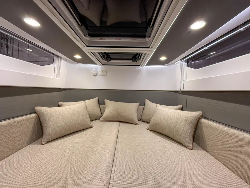 Slide: The Image of Luxurious cabin interior of 2020 Axopar 37 XC with plush cushions and ambient lighting. - 25