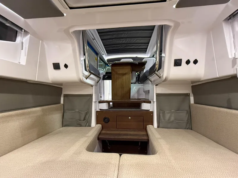 Slide: The Image of 2020 Axopar 37 XC cabin interior with beige seating and wooden accents. - 26
