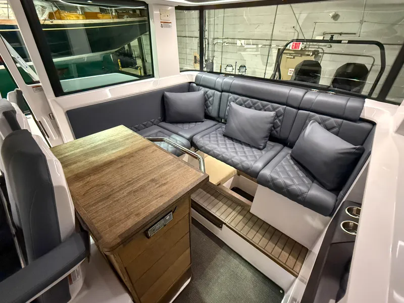Slide: The Image of Luxurious interior of 2020 Axopar 37 XC with plush seating and wooden table. - 27