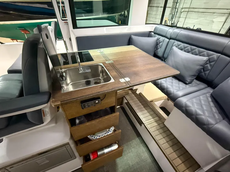 Slide: The Image of 2020 Axopar 37 XC interior with kitchenette, sink, and cushioned seating area. - 29