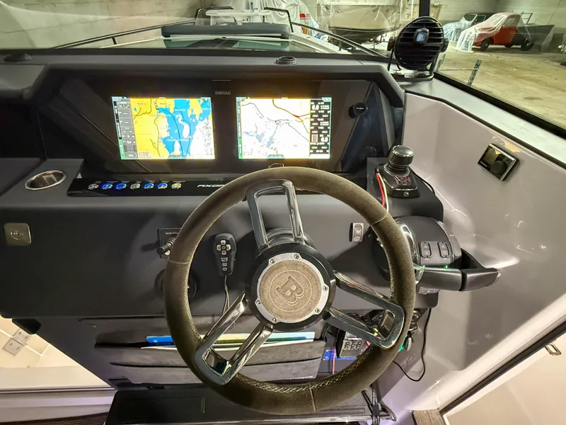 Slide: The Image of 2020 Axopar 37 XC dashboard with dual navigation screens and steering wheel. - 35
