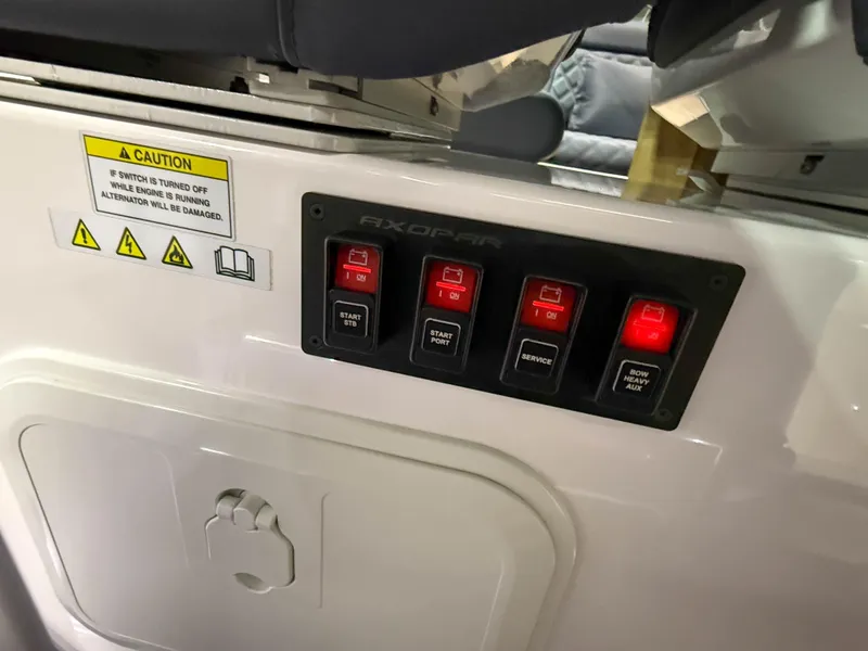 Slide: The Image of Control panel on a 2020 Axopar 37 XC boat with illuminated switches and caution label. - 36