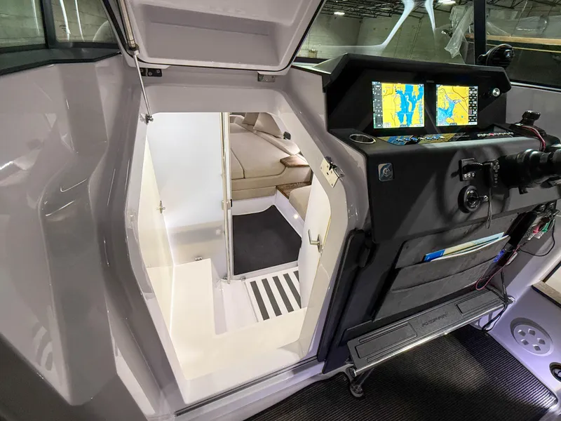 Slide: The Image of 2020 Axopar 37 XC cabin interior with navigation screens and seating area. - 37