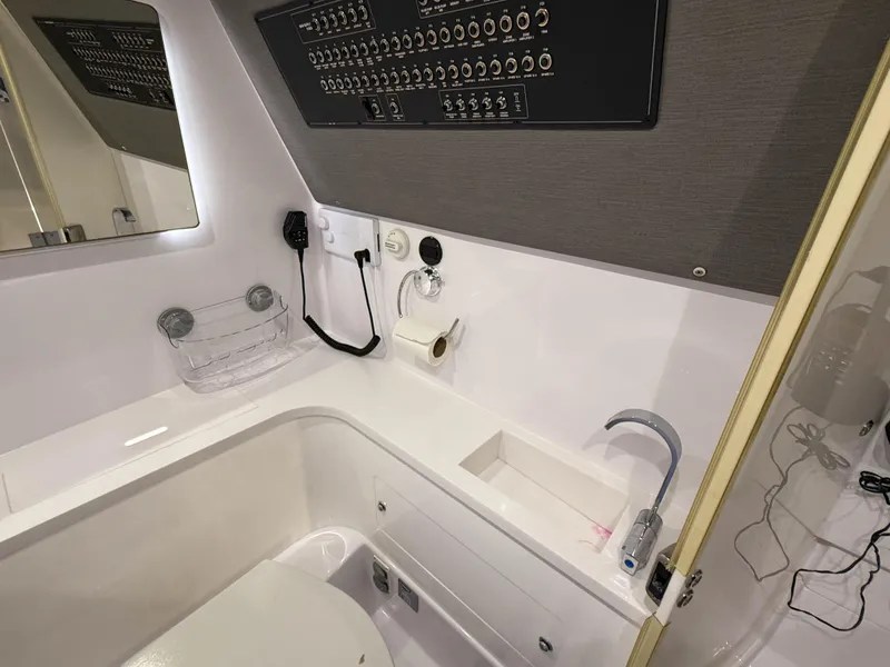 Slide: The Image of 2020 Axopar 37 XC boat bathroom with modern fixtures and control panel. - 41