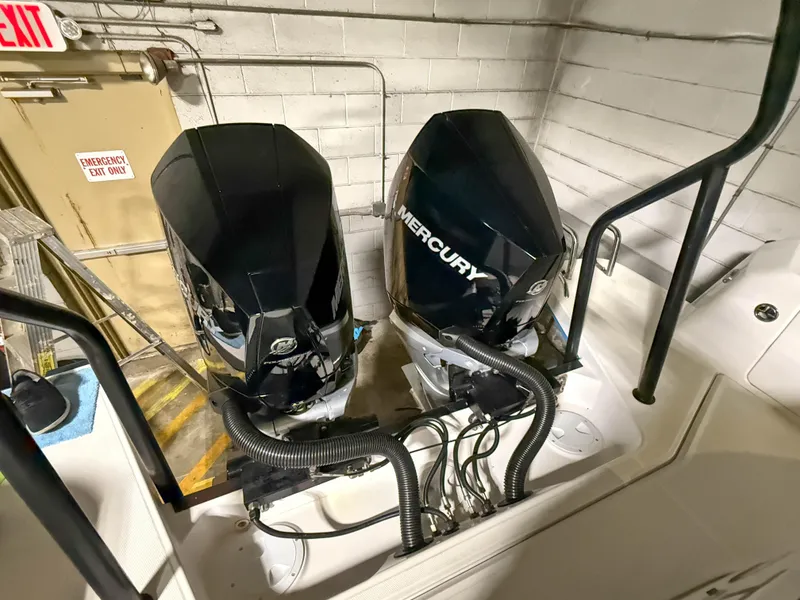 Slide: The Image of Twin Mercury outboard engines on a 2020 Axopar 37 XC boat in a garage setting. - 47