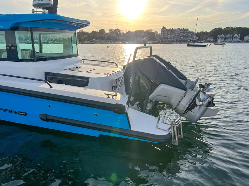 Slide: The Image of 2020 Axopar 37 XC boat on water at sunset, featuring sleek design and powerful outboard motor. - 6