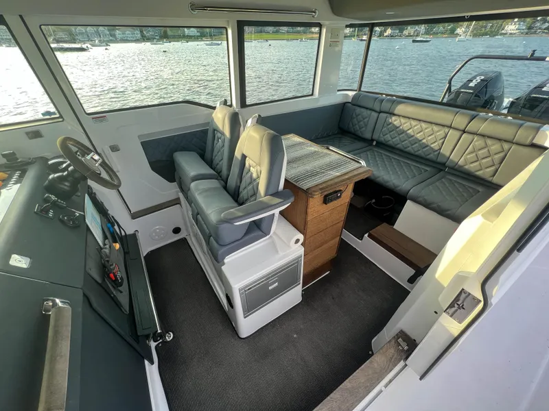 Slide: The Image of Interior of 2020 Axopar 37 XC boat with seating and helm, overlooking water. - 7