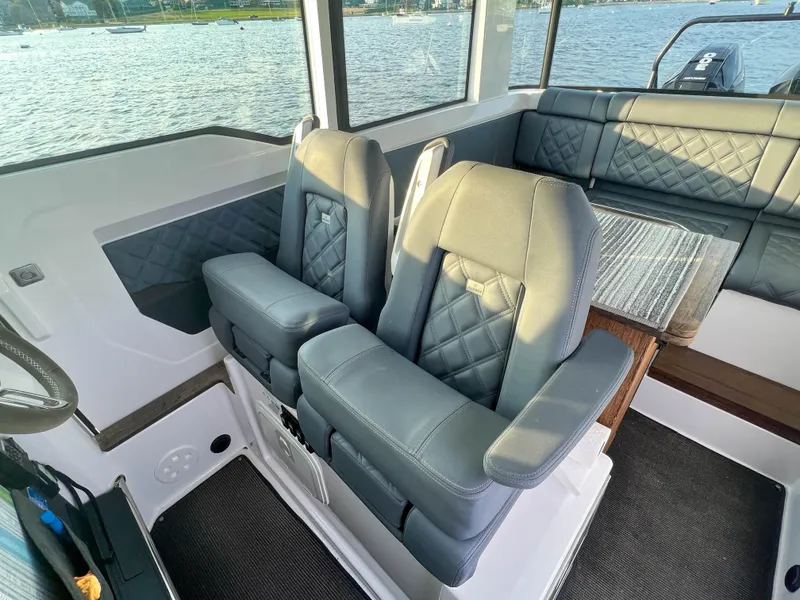 Slide: The Image of 2020 Axopar 37 XC interior with luxurious seating and waterfront view. - 8
