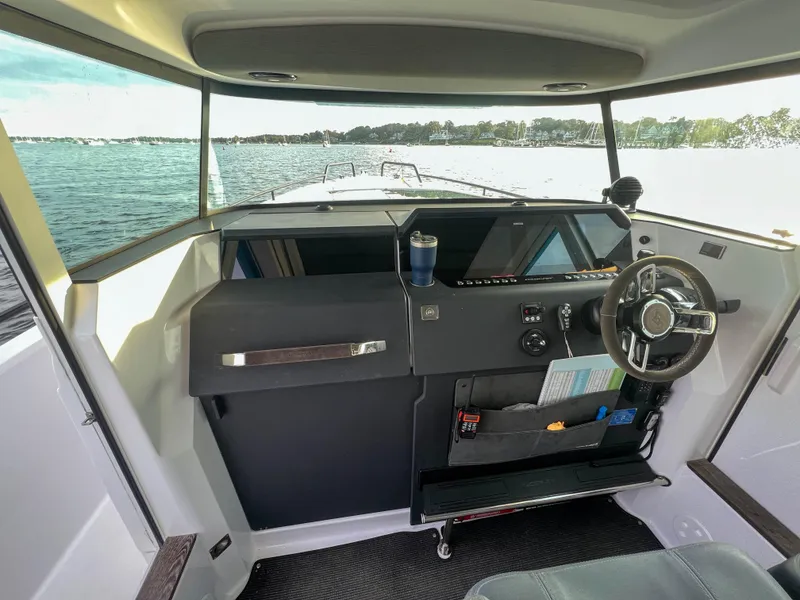 Slide: The Image of 2020 Axopar 37 XC helm with steering wheel, dashboard, and water view. - 9