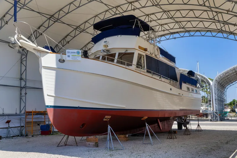 Slide: The Image of 1994 Grand Banks 49 Motoryacht in dry dock under a large canopy. - 1