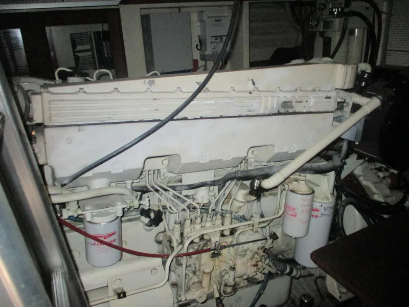 Slide: The Image of Engine room of 1994 Grand Banks 49 Motoryacht, showcasing mechanical components and filters. - 15