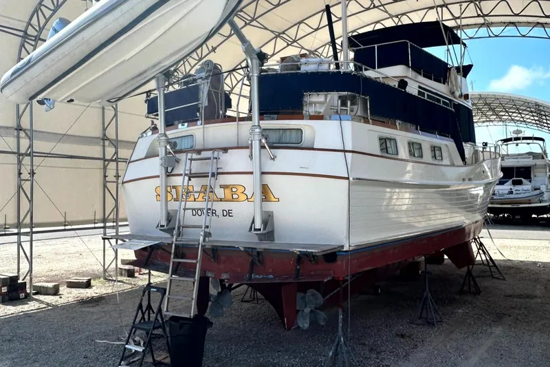 Slide: The Image of 1994 Grand Banks 49 Motoryacht in dry dock, rear view, under a canopy. - 2