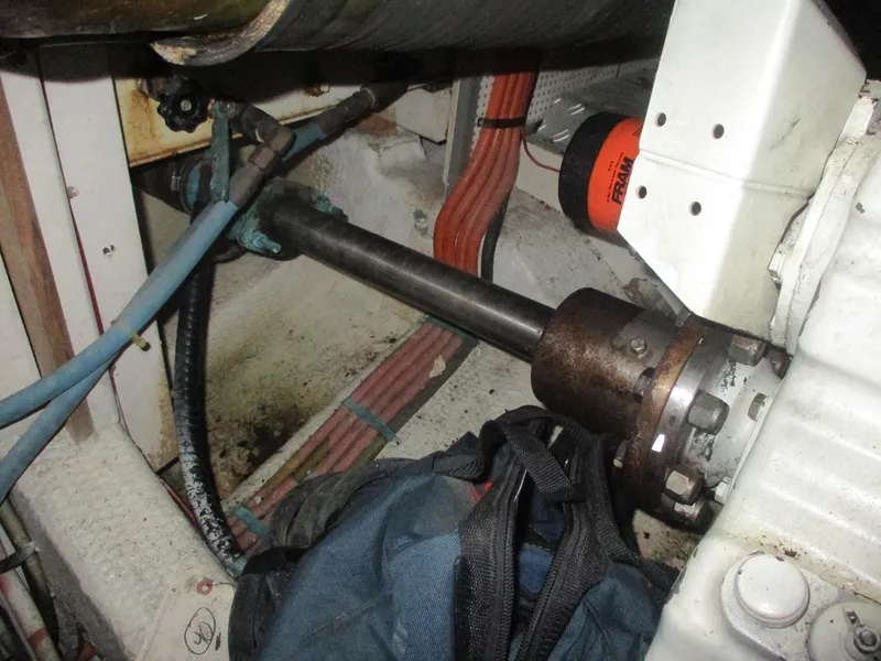 Slide: The Image of Engine room of 1994 Grand Banks 49 Motoryacht, showing mechanical components and hoses. - 25