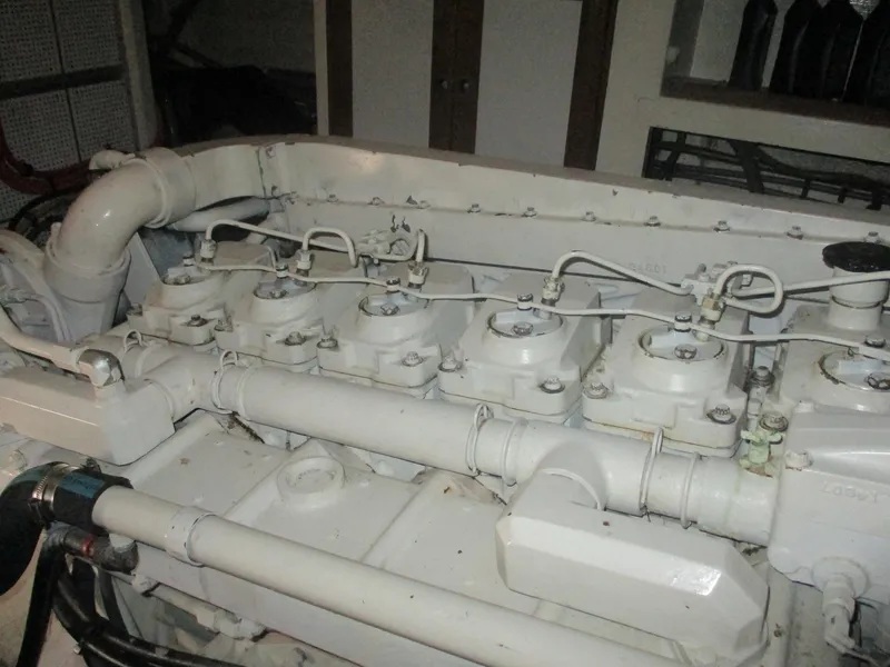 Slide: The Image of Engine of 1994 Grand Banks 49 Motoryacht, showcasing mechanical components and piping. - 30